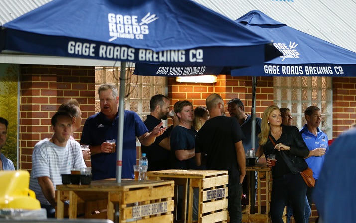 A photo of multiple people food and drinks under some marquees at HBF Park