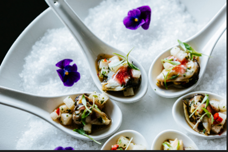 Top down shot of spoons filled with food in a circle